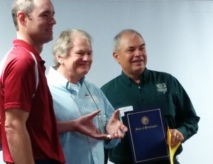 Greg Kinsinger receives award from Clinton O'Keefe, Conservation Commission Supervisor, and Mark Clark, Executive Director, WSCC